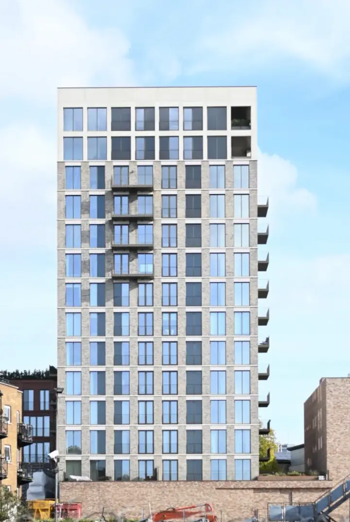 Architectural photography, tall building against blue sky by OhBe London
